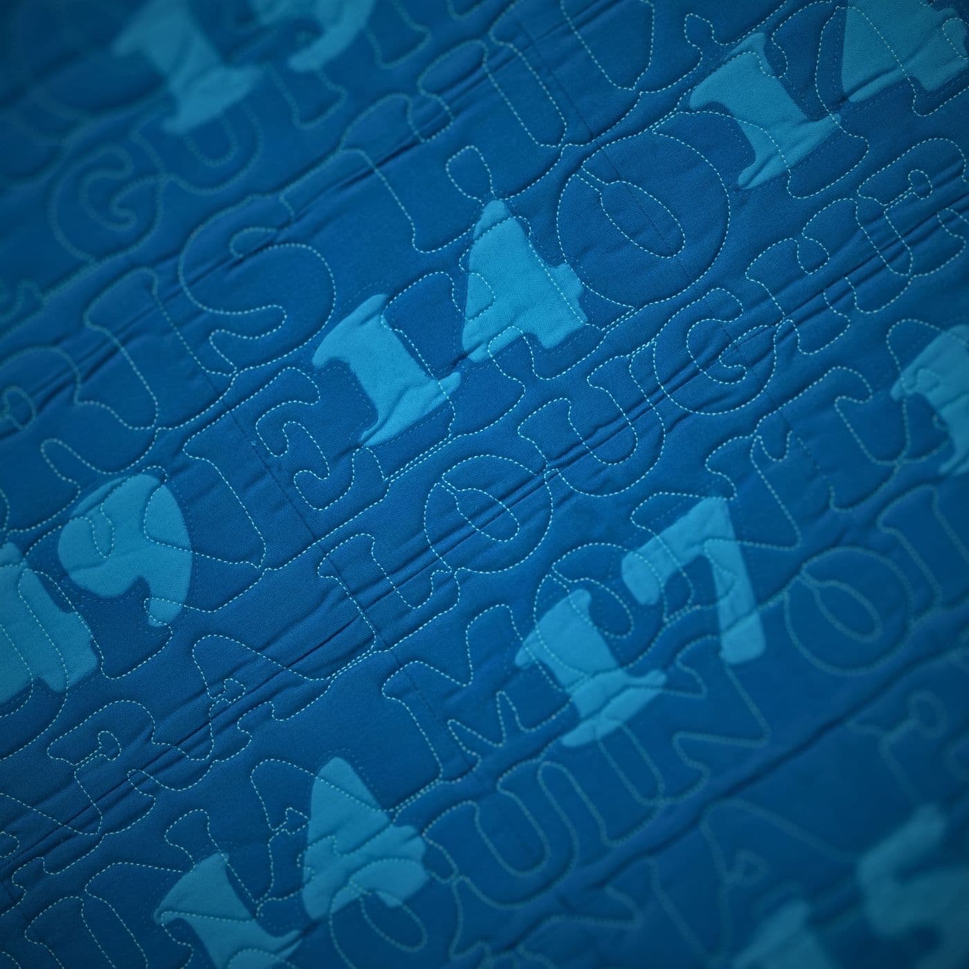 a blue art-quilt with light blue numbers